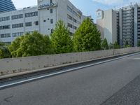 a young woman riding a skateboard down the side of a road in a city