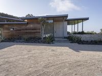 the modern looking house is located in the desert near the ocean and looks like an art deco home