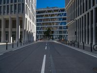 the empty street with bicycles parked in front of the buildings has a sign that says the library on it