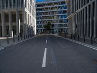 the empty street with bicycles parked in front of the buildings has a sign that says the library on it