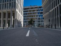 the empty street with bicycles parked in front of the buildings has a sign that says the library on it