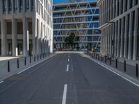 the empty street with bicycles parked in front of the buildings has a sign that says the library on it