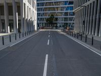 the empty street with bicycles parked in front of the buildings has a sign that says the library on it