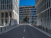 the empty street with bicycles parked in front of the buildings has a sign that says the library on it