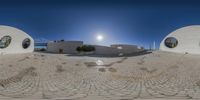 a panorama photo taken of the front entrance of a house on the beach with large circle windows and round mirrors in the windows