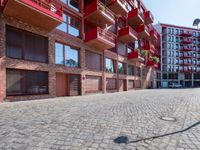 a building with a lot of windows sitting outside of it's door way is brick road