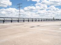 a photo of a runway and sky and road near by a large highway with wires in front