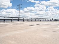 a photo of a runway and sky and road near by a large highway with wires in front