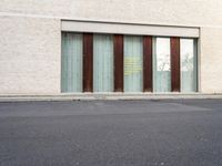 two doors sitting on the side of a building in front of some windows in a room