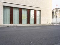 two doors sitting on the side of a building in front of some windows in a room