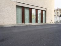 two doors sitting on the side of a building in front of some windows in a room