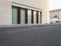 two doors sitting on the side of a building in front of some windows in a room