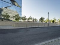 a large building sitting behind a fence near a street corner on a clear day in the evening