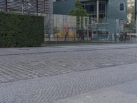 a red fire hydrant sitting on the side of a road next to a wall