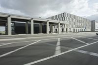 a city highway and the top of a building with columns is shown from a car window