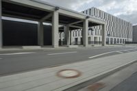 a city highway and the top of a building with columns is shown from a car window