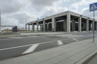 a city highway and the top of a building with columns is shown from a car window