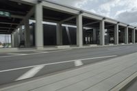 a city highway and the top of a building with columns is shown from a car window