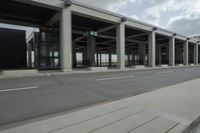 a city highway and the top of a building with columns is shown from a car window