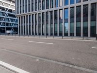 empty street with buildings next to it on the side of a building that has a bus in the middle