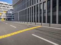 empty street with buildings next to it on the side of a building that has a bus in the middle