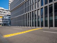 empty street with buildings next to it on the side of a building that has a bus in the middle