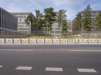 a very tall building next to a road with trees in the front of it that is made of stone