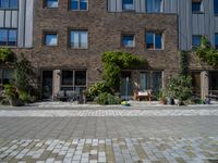 large brick building with patio and lawn in front of it's door way and window