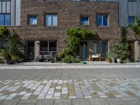 large brick building with patio and lawn in front of it's door way and window