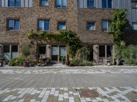 large brick building with patio and lawn in front of it's door way and window