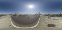 a skateboarder is riding on top of a ramp next to a drain,