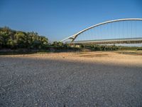 there are two very long bridges that are above the river shore at dusk here, and you can see how close them are