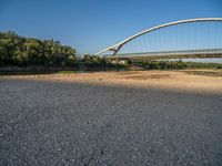 there are two very long bridges that are above the river shore at dusk here, and you can see how close them are