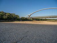 there are two very long bridges that are above the river shore at dusk here, and you can see how close them are