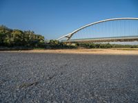 there are two very long bridges that are above the river shore at dusk here, and you can see how close them are