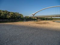 there are two very long bridges that are above the river shore at dusk here, and you can see how close them are