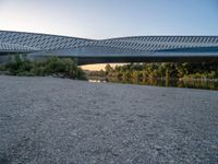 there are two very long bridges that are above the river shore at dusk here, and you can see how close them are