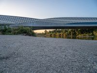 there are two very long bridges that are above the river shore at dusk here, and you can see how close them are