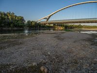 there are two very long bridges that are above the river shore at dusk here, and you can see how close them are