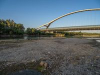 there are two very long bridges that are above the river shore at dusk here, and you can see how close them are