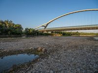 there are two very long bridges that are above the river shore at dusk here, and you can see how close them are