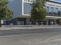 a modern building with many trees growing out the side and in front of it,