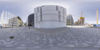 a fish eye view of a building in the city setting with a circular brick pattern