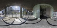 the reflection of a circular room is shown in this mirror image and it shows the outside courtyard