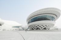 a modern building is on the street in china, with an artistic pattern on its facade