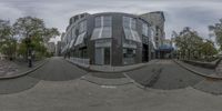 a wide angle view of a building from the street in front of it and people on the sidewalk