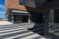 there is an entrance into a modern building on a sunny day with blue skies in the background