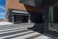 there is an entrance into a modern building on a sunny day with blue skies in the background