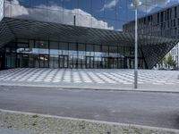 a modern looking building with the reflection of the glass facade on it's side