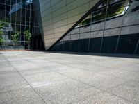 the view of the exterior of a modern looking building in daylight time with reflection of its windows